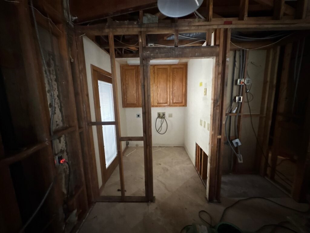 Apartment unit stripped to the studs during dry out after water damage from a roof leak